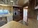 A kitchen area featuring stainless steel refrigerator, built in oven and a window with bright light at 8269 E Desert Trl, Mesa, AZ 85208