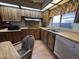 Galley kitchen with wood cabinets, laminate countertops, and modern appliances at 8269 E Desert Trl, Mesa, AZ 85208