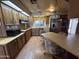 Traditional kitchen with wood cabinets, stainless steel appliances, and a dining area with a table and chairs at 8269 E Desert Trl, Mesa, AZ 85208