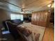 Comfortable living room with plush seating, carpeted floor, and wood-paneled walls at 8269 E Desert Trl, Mesa, AZ 85208