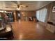 Spacious living area with wood paneling, natural light, and laminate flooring at 8269 E Desert Trl, Mesa, AZ 85208
