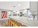 Bright, modern kitchen with white cabinets, quartz countertop breakfast bar and stainless steel appliances at 8338 E Stella Ln, Scottsdale, AZ 85250