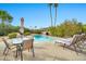 Inviting pool area with comfortable lounge chairs and dining table providing a relaxing outdoor space for entertaining and leisure at 8338 E Stella Ln, Scottsdale, AZ 85250