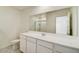 Bright bathroom featuring a large mirror, white cabinets, and a single sink at 9832 W Agora Ln, Tolleson, AZ 85353