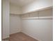 Spacious walk-in closet with ample shelving and neutral carpeting at 9832 W Agora Ln, Tolleson, AZ 85353