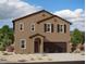 Two-story home showcases a contemporary design with a stucco exterior, and a two-car garage at 9832 W Agora Ln, Tolleson, AZ 85353