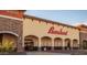 Exterior view of Bashas' grocery store in strip mall, providing convenient shopping options for community members at 10320 E Sunburst Dr, Sun Lakes, AZ 85248