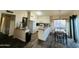 Bright kitchen featuring white cabinetry, laminate floors and a dining area at 1035 W Laguna Dr, Tempe, AZ 85282