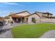 Lush backyard featuring a well-maintained lawn, a desert cactus, and a charming pergola at 10721 W Jefferson St, Avondale, AZ 85323