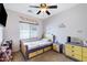 This bedroom features a ceiling fan, carpet flooring, and colorful decorations at 10721 W Jefferson St, Avondale, AZ 85323