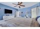 Bright bedroom with a ceiling fan, white furnishings, and a flatscreen television at 10721 W Jefferson St, Avondale, AZ 85323