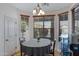 A dining area features a chandelier, lots of natural light, and views of the exterior of the home at 10721 W Jefferson St, Avondale, AZ 85323