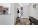 Entryway featuring tile floors, a coat rack, and an inviting view into the kitchen area at 10721 W Jefferson St, Avondale, AZ 85323