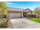 Single-story home showcasing a well-maintained front yard and spacious driveway at 10721 W Jefferson St, Avondale, AZ 85323