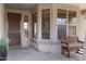 Inviting front porch features a bench and decorative elements, offering a cozy welcome at 10721 W Jefferson St, Avondale, AZ 85323