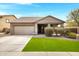 Charming single-story home featuring a well-manicured lawn and desert landscaping at 10721 W Jefferson St, Avondale, AZ 85323