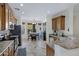 A kitchen features tile floors, granite countertops, wood cabinets, stainless steel appliances, and an adjacent dining area at 10721 W Jefferson St, Avondale, AZ 85323