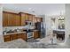 The kitchen features wood cabinets, stainless steel appliances, granite counters, and a breakfast nook with natural light at 10721 W Jefferson St, Avondale, AZ 85323