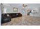 Inviting living room showcases tile flooring, a leather sofa, and a view into the kitchen area at 10721 W Jefferson St, Avondale, AZ 85323