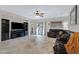 Open living space features tile flooring, ceiling fan, and a comfortable leather sofa at 10721 W Jefferson St, Avondale, AZ 85323