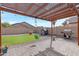 Charming pergola with string lights, a grill and backyard toys on a lush green lawn at 10721 W Jefferson St, Avondale, AZ 85323