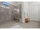 Well-lit shower showcases modern design with glass door, built-in bench, and neutral toned tile at 11241 N Blakely St, Surprise, AZ 85388