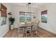 Inviting dining area with a wood table, stylish chairs, and natural light from surrounding windows at 11241 N Blakely St, Surprise, AZ 85388