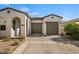 Charming house with a two-car garage, well-manicured landscaping, and a paved driveway at 11241 N Blakely St, Surprise, AZ 85388