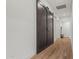 Hallway view featuring a barn door and wood-look tile flooring at 11241 N Blakely St, Surprise, AZ 85388
