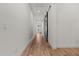 Hallway featuring wood-look tile flooring, white walls, and sliding barn door at 11241 N Blakely St, Surprise, AZ 85388