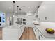 Bright white kitchen with a center island, stainless appliances, and modern cabinetry with sleek hardware at 11241 N Blakely St, Surprise, AZ 85388