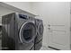 Modern laundry room featuring a gray washer and dryer set with a neutral-toned floor at 11241 N Blakely St, Surprise, AZ 85388