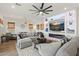 A comfy living room area featuring a large ceiling fan and modern decor at 11241 N Blakely St, Surprise, AZ 85388
