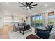 Open-concept living room connected to a kitchen and outdoor patio space at 11241 N Blakely St, Surprise, AZ 85388
