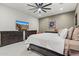 Well-lit main bedroom featuring a king bed, dark furniture, and a ceiling fan at 11241 N Blakely St, Surprise, AZ 85388