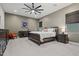 Comfortable main bedroom with a ceiling fan, neutral walls, and coordinated furniture set at 11241 N Blakely St, Surprise, AZ 85388