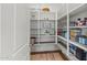 Organized pantry with open shelving, providing ample storage for kitchen essentials and supplies at 11241 N Blakely St, Surprise, AZ 85388