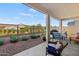 Covered patio with comfortable seating and a view of the manicured backyard at 11241 N Blakely St, Surprise, AZ 85388