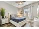 Bright bedroom featuring a ceiling fan, wood floors, a window, and a comfortable bed at 11673 N 136Th St # 1019, Scottsdale, AZ 85259