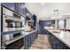 Modern kitchen showcasing stainless steel appliances, blue cabinets, and plenty of counter space at 11673 N 136Th St # 1019, Scottsdale, AZ 85259