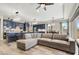Open-concept living room featuring a comfortable sectional sofa, stylish decor, and seamless flow to the kitchen at 11673 N 136Th St # 1019, Scottsdale, AZ 85259