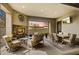 Charming covered patio with fireplace, cozy seating, dining table, and serene outdoor view at 11673 N 136Th St # 1019, Scottsdale, AZ 85259