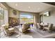 A stylish outdoor entertaining area featuring a fireplace, seating, a dining table, and desert views at 11673 N 136Th St # 1019, Scottsdale, AZ 85259