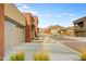 Modern home exterior with a two-car garage, desert landscaping, and mountain views in the distance at 11673 N 136Th St # 1019, Scottsdale, AZ 85259