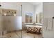 Bright bathroom featuring a glass enclosed shower and clawfoot bathtub with decorative detailing and tile flooring at 12238 E Poinsettia Dr, Scottsdale, AZ 85259