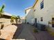 Well maintained backyard featuring desert landscaping and a paver walkway to a back gate at 12403 W Monte Vista Rd Rd, Avondale, AZ 85392