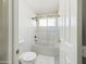 Bathroom with tiled bath and glass doors at 12403 W Monte Vista Rd Rd, Avondale, AZ 85392