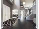 Elegant foyer with dark hardwood floors, staircase with white railing, and views into other living spaces at 12403 W Monte Vista Rd Rd, Avondale, AZ 85392