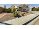 Well-manicured front yard with desert landscaping showcasing a variety of cacti and succulents in an appealing rock bed at 12403 W Monte Vista Rd Rd, Avondale, AZ 85392