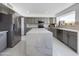Bright kitchen featuring gray cabinets, stainless steel appliances, a large island and beautiful white countertops at 12403 W Monte Vista Rd Rd, Avondale, AZ 85392